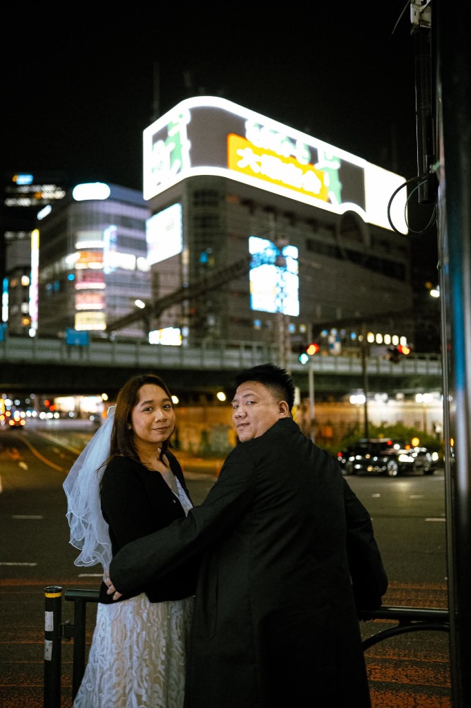 Rey and Kim on a city street at night